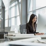 Asian woman using desktop computer