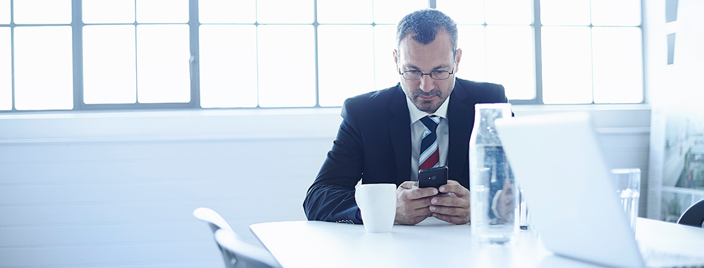 Businessman using smartphone in office