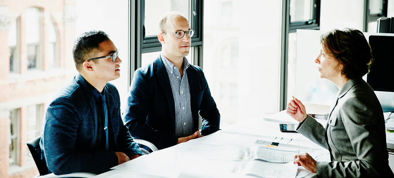 business men being consulted with by business woman